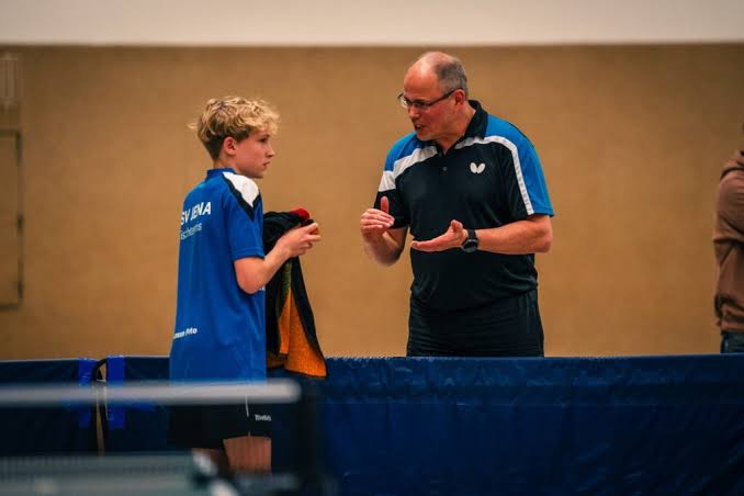 Dr. Mathias Völzke im Gespräch mit einem jungen Tischtennisspieler